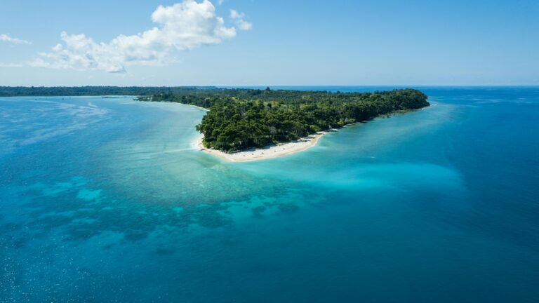 Stunning drone view of Kadamtala Island with clear blue waters and lush greenery in India.