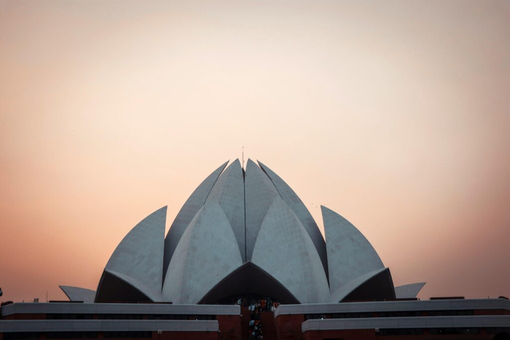 Stunning view of the Lotus Temple in New Delhi at sunset, showcasing modern architecture.