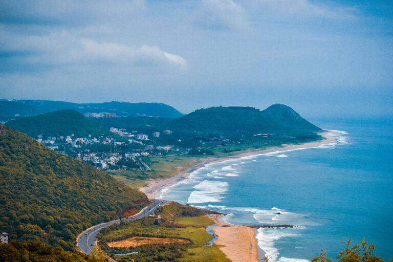 A breathtaking aerial view of the coastline in Visakhapatnam, capturing lush hills and the vibrant sea.